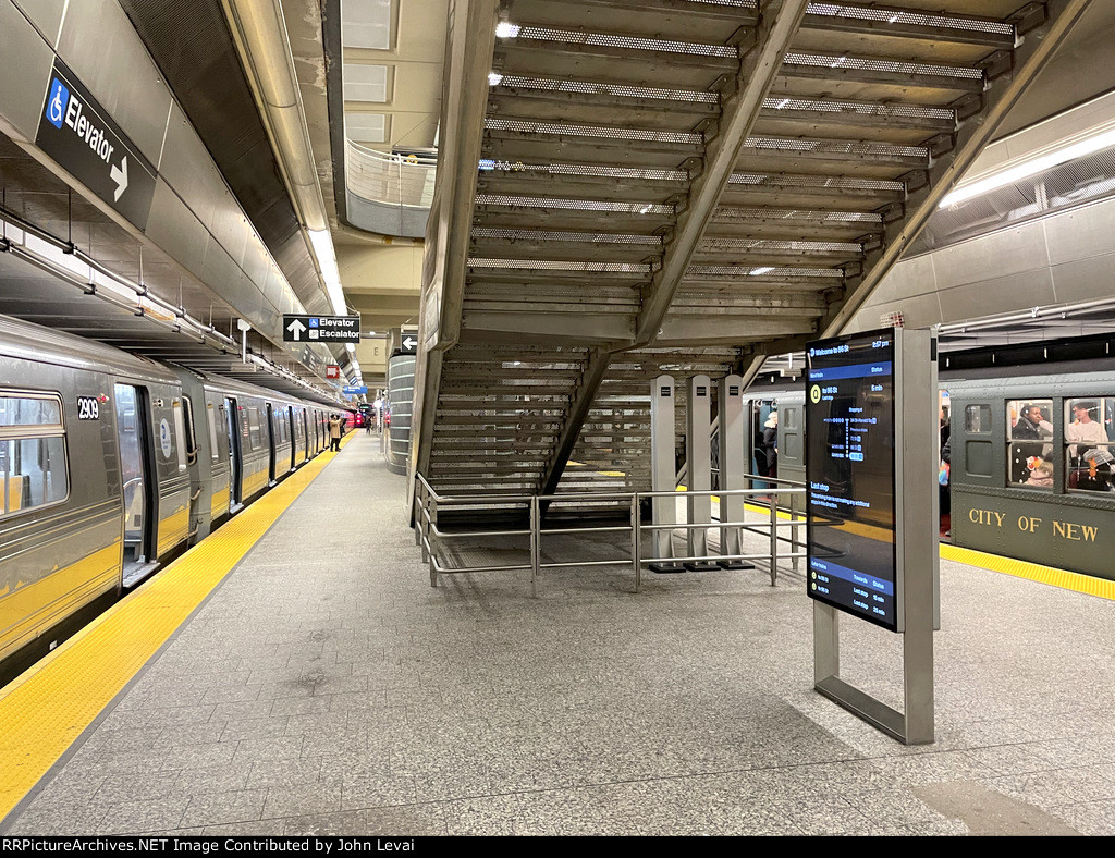 At 96th St Station, the Holiday Arnine Set sits on the right and on the left is a regular Q train set